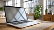 © wiwat apisithpinyo - Modern Laptop on Wooden Table in Bright Office Space with Large Windows and Natural Light