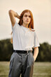 © Bliss - Redhead young man showcases stylish autumn outfit during golden hour outdoors