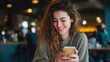 © Johannes - young beautiful woman holding coffee paper cup and looking at smartphone while sitting at cafeteria happy university student girl using mobile phone businesswoman drinking coffee and smiling no logos