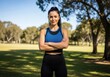 © ZAKARIYAE - Confident Woman Fitness Coach Standing Outdoors in a Park Ready for a Workout Session
