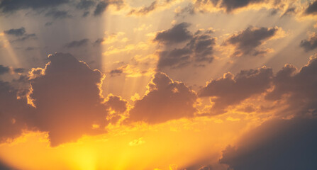 Wall Mural - Bright orange sunset sky background with dramatic clouds. 