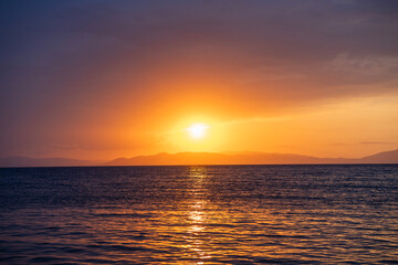 Wall Mural - Beautiful sunset over the lake and mountains.