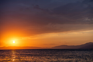 Wall Mural - Beautiful sunset over the lake and mountains. 