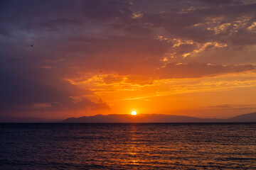 Wall Mural - Beautiful sunset over the lake and mountains.