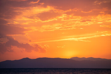 Wall Mural - Beautiful sunset over the lake and mountains.