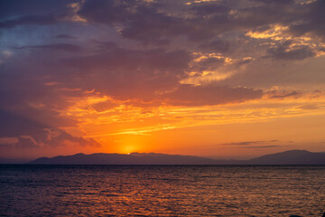 Wall Mural - Beautiful sunset over the lake and mountains.