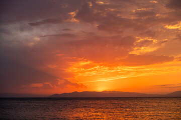 Wall Mural - Beautiful sunset over the lake and mountains.