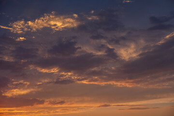 Wall Mural - Bright orange sunset sky background with dramatic clouds. 