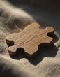 © Aliaksandr Barouski - Wooden puzzle piece on a textured fabric background, showcasing its natural grain
