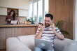 © Migma_Agency - Freelancer working from home having phone call using speaker mode