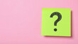 © Dzunstock - A bright green sticky note with a large black question mark on a pink background, symbolizing curiosity or inquiry.