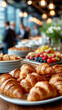 © ABF_MATEO - An assortment of pastries and fruits are arranged for an office breakfast or corporate event. Croissants are in foreground.