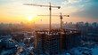 © khemthong - Construction site with cranes at sunset. Construction of an apartment building