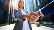© MD ZIHAD HASAN - Successful Business Partnership Agreement Celebration with Handshake Between Professionals Outside Modern Office Buildings in Downtown City Financial District