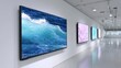 © BOJOShop - Large screen displays showing art including ocean waves and floral patterns mounted on a white gallery wall