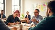 © Mey - A group of people in a casual office setting, engaged in a discussion.