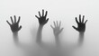 © Scetsa - Four shadowy hands reach upward through a hazy, translucent surface, creating a ghostly, unsettling effect