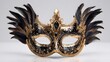 © rehan - Ornate black and gold venetian mask with decorative feathers.