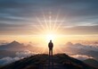 © Jchanism - A lone figure stands atop a mountain above the clouds facing the radiant sunrise symbolizing hope clarity and the limitless opportunities that come with each new beginning