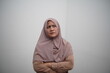 © airdone - Asian muslim woman looking up with serious thinking expression, concept of having hard problems to solve
