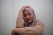 © airdone - Depressed Asian muslim woman crying in pain and regret, concept of sad hearing bad news or being victim in a conflict
