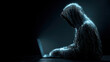 © Annamorphosis - Side profile of digital hacker representing cybersecurity threat on a laptop.