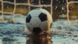 © john - A soccer ball splashes in a puddle near a goalpost during a rainy day, capturing the action