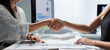 © crizzystudio - Businesswomen shaking hands after successful meeting in office