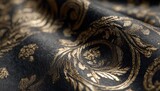 Dark fabric with gold baroque-style damask pattern, richly textured and subtly shimmering, showcasing elegant folds and intricate detailing