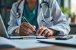 © MDBAKHTIAR - Doctor wearing stethoscope writing on clipboard with laptop and phone