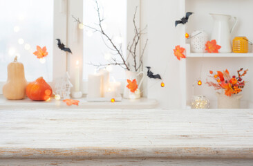 Wall Mural - halloween holiday bleached wooden table space in front of blurred window with traditional decoration