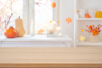 Wall Mural - wooden table with copy space on blurred interior background decorated with traditional halloween hol