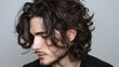 © PixelPerfect - Profile portrait of a man with long messy wavy hair