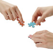 © emaris - Three distinct hands carefully bring together individual colorful puzzle pieces, symbolizing collaborative problem-solving, teamwork, and the intricate process of achieving a common goal.