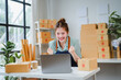 © PaeGAG - Asian female entrepreneur celebrating success in online business store