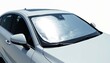 © Pete - Car sunshade installed on front windscreen. Silver metallic automotive accessory protects interior from sun, heat, ultraviolet rays, glare. Enhances driver, passenger comfort, safety. Reflective