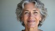 © Pete - Portrait of smiling mature woman with short, wavy, gray hair, pleasant expression. Elegant style, healthy appearance convey confidence, natural beauty, making attractive representation of middle-aged