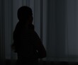© New Africa - Silhouette of sad young woman at home. space for text