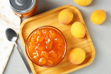 Wall Mural - tasty apricot jam and fresh fruits on light grey table, flat lay