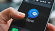 © Muhammad - A person using the signal app on a smartphone with the finger touching the screen and black background