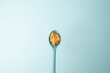 © Deborah - Blue spoon full of crunchy, creamy peanut butter over a blue background.  Copy space.