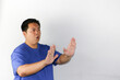 © FxErickMartin - Portrait asian guy  making rejection gesture and saying no to camera