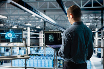 Data center IT specialist monitoring AI LLM visualization output to verify inference patterns. Programmer analyzing neural language network structure in server room using laptop