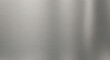 © Earthen Stock - A high-quality close-up of a brushed stainless steel surface, showing its fine, horizontal grain.