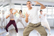 © JackF - During dance workshop, guy enjoys active dancing, learns new movements, moves synchronously with participants of lesson. Concept of beautiful body through sports, dancing, and active lifestyle