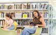 © JackF - University students, boys and girls, sit in the chairs of the university library and read books. Preparing for exams