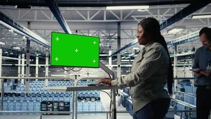 Server room female programmer using green screen computer to scan infrastructure for issues. Data center worker uses mockup PC to organize file backups and plan recovery steps, camera A