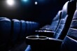 © oksa_studio - Comfortable leather seats with cup holders are waiting for viewers in dark cinema or theater auditorium