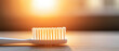 © nattapon98 - Glowing toothbrush with soft bristles illuminated by warm sunlight on wooden surface, creating calm and clean atmosphere