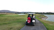 © sittinan - People playing golf on beautiful course , swinging and hitting golf ball , luxury vacation